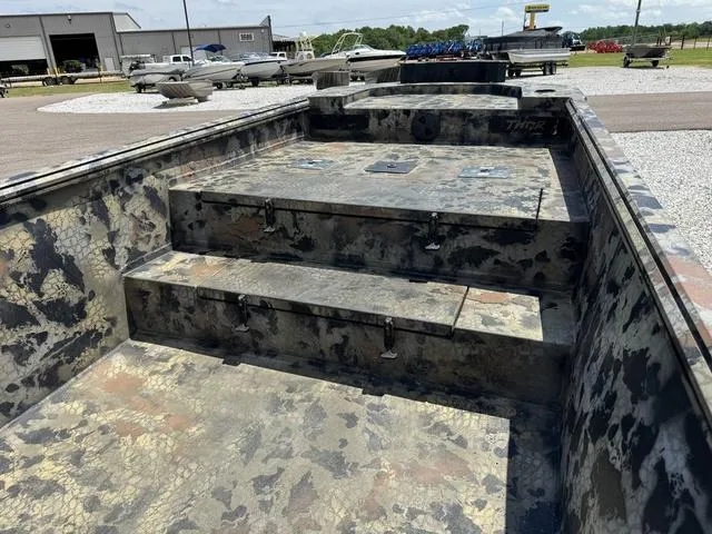 Slide: The Image of 2023 Thor Boats Lake Hammer Standard with camouflage interior, parked outdoors. - 5