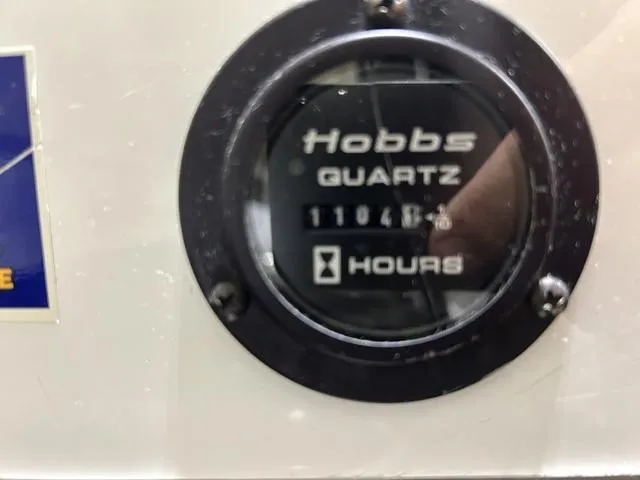 Slide: The Image of Hobbs Quartz hour meter displaying 11048.8 hours on a 2003 Cobalt 226. - 10