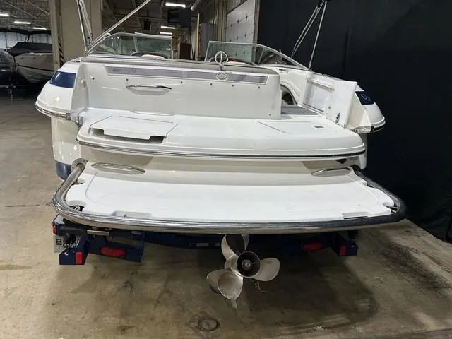 Slide: The Image of 2003 Cobalt 226 boat in a warehouse, showcasing rear view and propeller. - 17