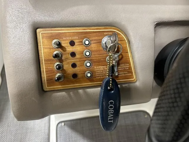 Slide: The Image of Control panel of a 2003 Cobalt 226 boat with ignition key and switches. - 2