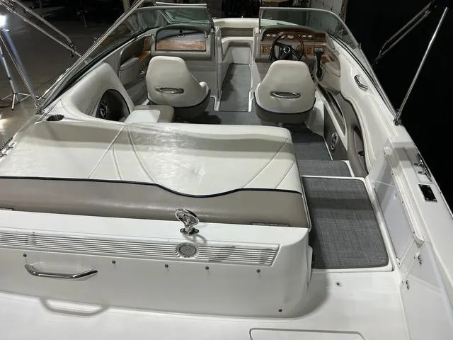 Slide: The Image of 2003 Cobalt 226 boat interior with white seating and wooden dashboard. - 20
