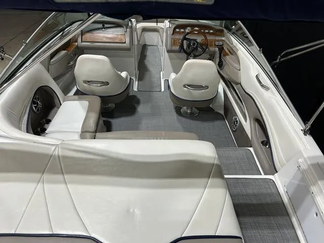 Slide: The Image of Interior of a 2003 Cobalt 226 boat with white seating and modern dashboard. - 21