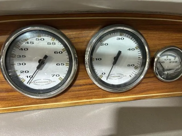 Slide: The Image of Dashboard gauges of a 2003 Cobalt 226 boat, featuring speedometer, tachometer, and temperature gauge. - 25