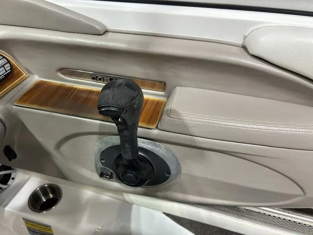 Slide: The Image of Interior of a 2003 Cobalt 226 boat with throttle control and wood accents. - 27