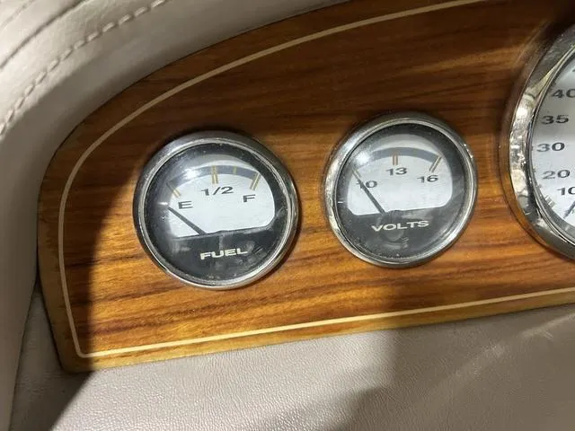 Slide: The Image of Dashboard of 2003 Cobalt 226 with fuel and volt gauges on wood panel. - 3