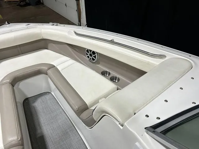 Slide: The Image of 2003 Cobalt 226 boat interior with beige seating, cup holders, and speaker. - 30