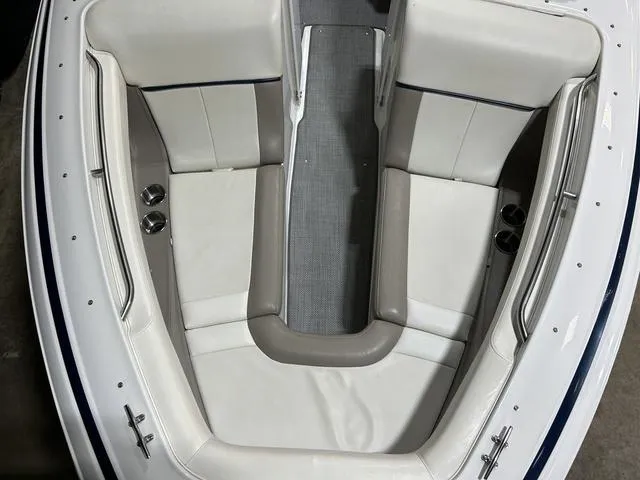 Slide: The Image of 2003 Cobalt 226 boat interior with white and beige seating, cup holders, and sleek design. - 31