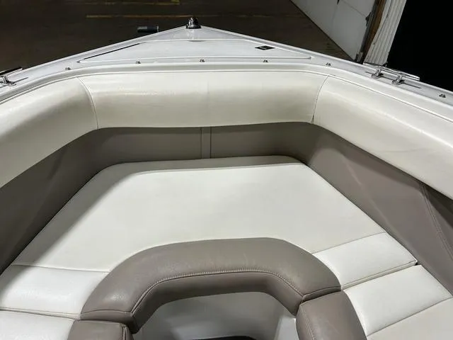 Slide: The Image of Interior seating of a 2003 Cobalt 226 boat, featuring white and beige upholstery. - 8