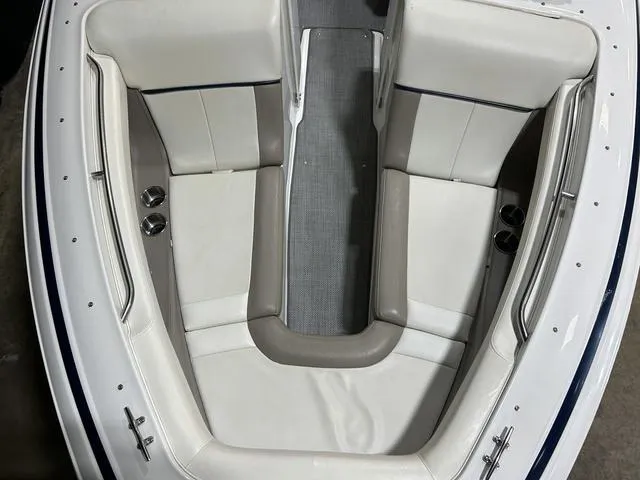 Slide: The Image of 2003 Cobalt 226 boat interior with white and beige seating, overhead view. - 9