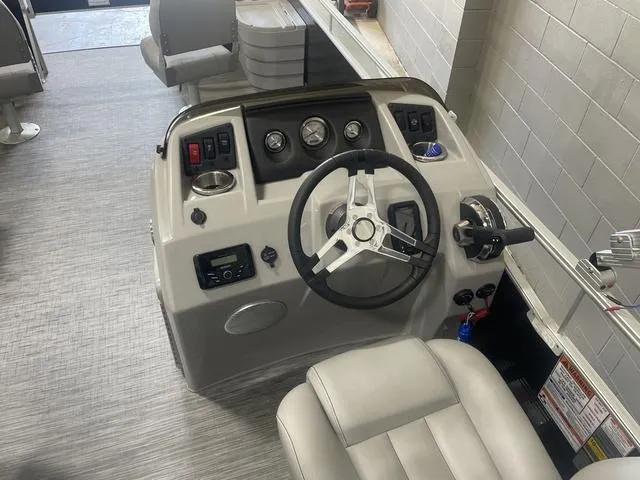 Slide: The Image of 2023 Bennington 20 SVF boat dashboard with steering wheel and control panel. - 11
