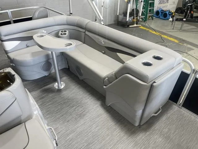 Slide: The Image of 2023 Bennington 20 SVF pontoon boat interior with gray seating and table. - 20