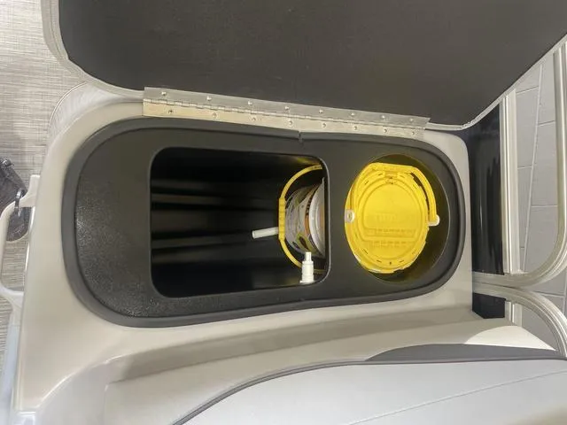Slide: The Image of Storage compartment in 2023 Bennington 20 SVF boat with yellow lid and hose. - 22