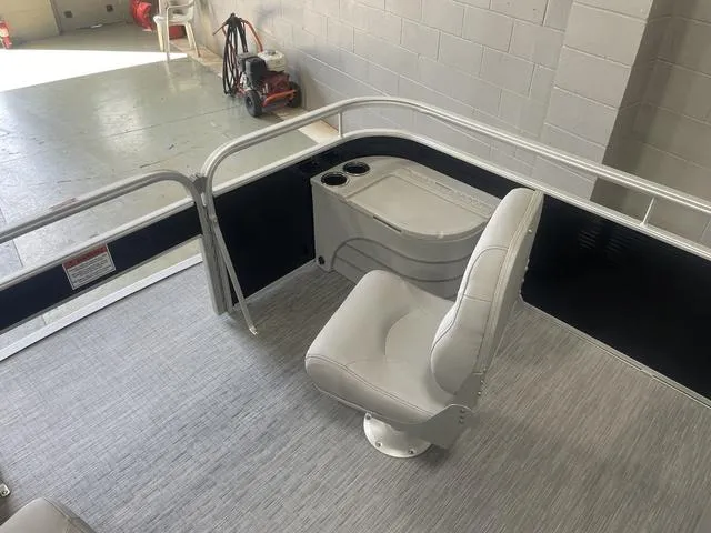 Slide: The Image of 2023 Bennington 20 SVF boat interior with a single seat and cup holders. - 24