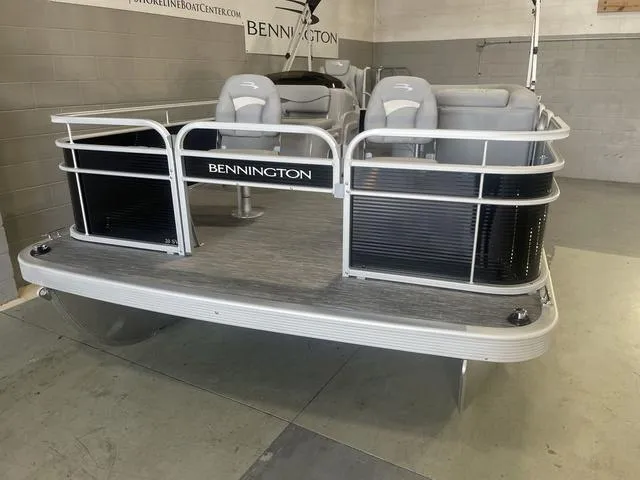 Slide: The Image of 2023 Bennington 20 SVF pontoon boat in showroom, featuring sleek design and comfortable seating. - 3