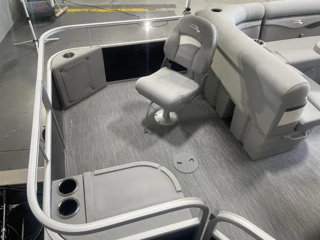 Slide: The Image of 2023 Bennington 20 SVF pontoon boat interior with gray seating and flooring. - 9