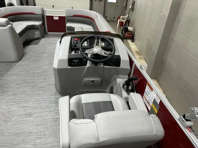 Slide: The Image of 2023 Bennington 24 SXL pontoon boat interior with steering console and seating. - 12