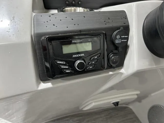 Slide: The Image of Kicker media center on 2023 Bennington 24 SXL boat dashboard, featuring audio input controls. - 13