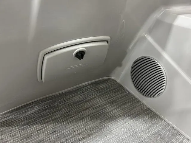Slide: The Image of Interior detail of 2023 Bennington 24 SXL boat, featuring a speaker and storage compartment. - 16