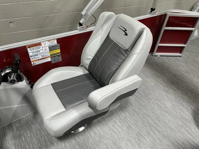 Slide: The Image of 2023 Bennington 24 SXL boat seat with gray and white upholstery, featuring ergonomic design. - 17