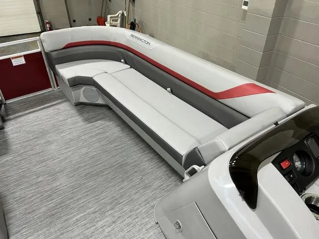 Slide: The Image of 2023 Bennington 24 SXL pontoon boat interior with gray and red seating. - 18