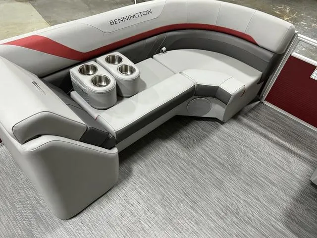 Slide: The Image of 2023 Bennington 24 SXL boat interior with gray seating and cup holders. - 19