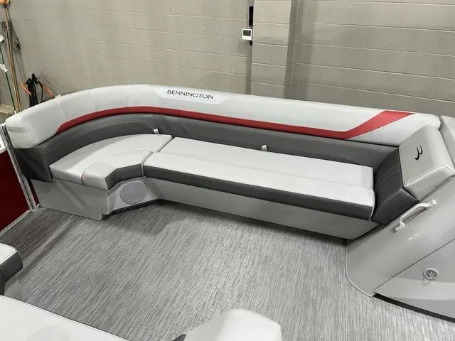 Slide: The Image of 2023 Bennington 24 SXL boat interior with gray and red seating. - 21