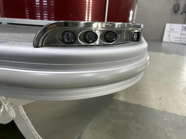 Slide: The Image of 2023 Bennington 24 SXL pontoon boat with sleek silver trim and integrated lighting. - 6