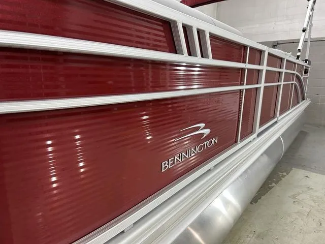 Slide: The Image of 2023 Bennington 24 SXL pontoon boat with sleek red exterior and silver accents. - 7