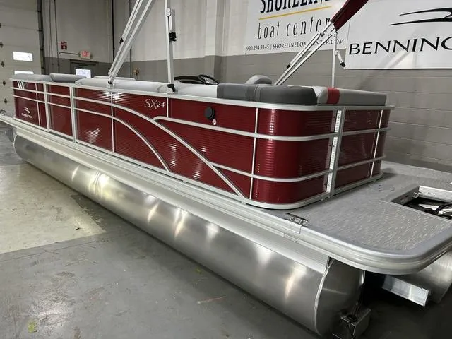 Slide: The Image of 2023 Bennington 24 SXL pontoon boat with red exterior in showroom. - 8