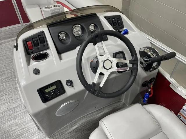 Slide: The Image of 2023 Bennington 20 SVL boat dashboard with steering wheel and control panel. - 10