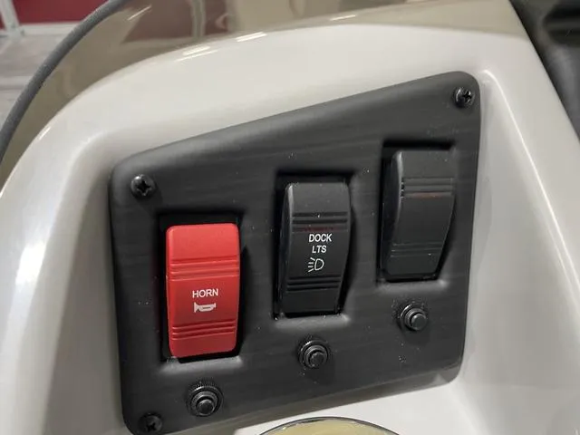 Slide: The Image of Control panel of 2023 Bennington 20 SVL boat with horn and dock light switches. - 13