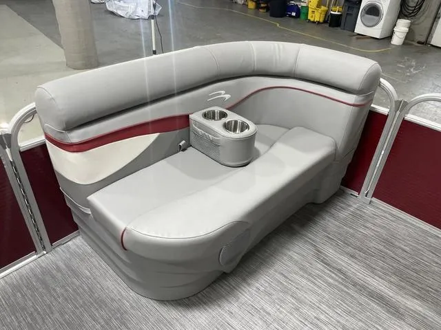 Slide: The Image of 2023 Bennington 20 SVL pontoon boat seating with cup holders, featuring gray and red upholstery. - 18