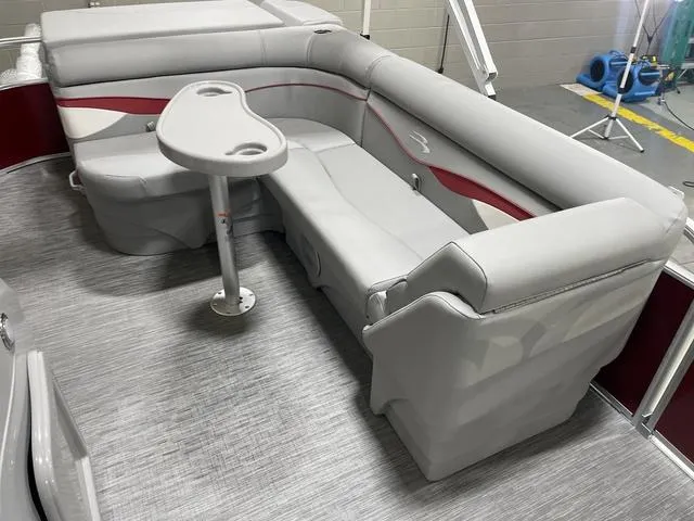 Slide: The Image of 2023 Bennington 20 SVL pontoon boat interior with gray seating and a small table. - 19