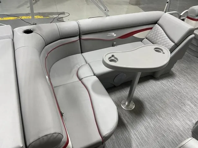 Slide: The Image of 2023 Bennington 20 SVL boat interior with gray seating and a small table. - 9