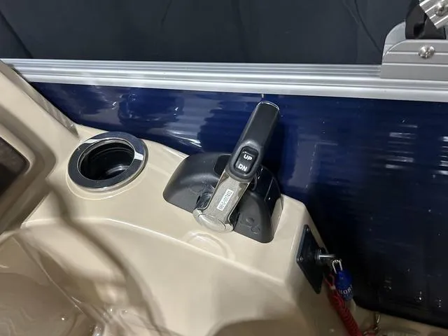 Slide: The Image of Control panel of a 2016 Bennington 2550 GSR boat with throttle lever and cup holder. - 15