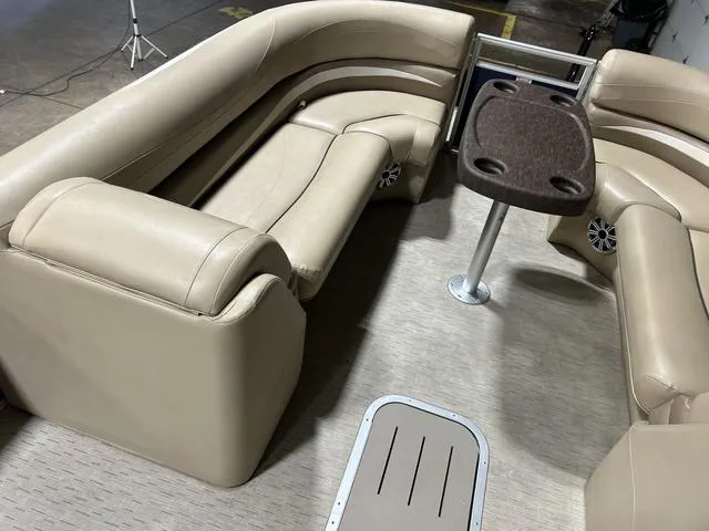 Slide: The Image of 2016 Bennington 2550 GSR boat interior with beige seating and table. - 20