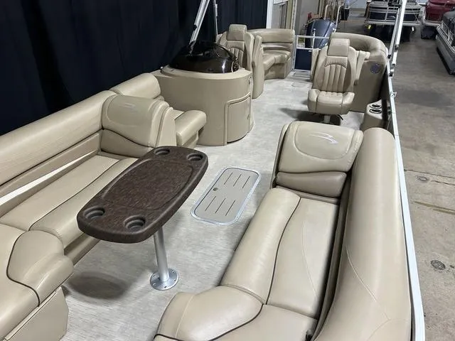 Slide: The Image of 2016 Bennington 2550 GSR pontoon boat with beige seating and a central table. - 22