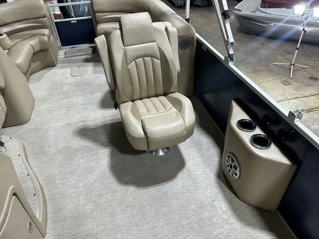 Slide: The Image of Luxurious interior of 2016 Bennington 2550 GSR pontoon boat with beige seating and cup holders. - 23