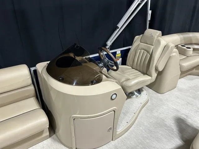 Slide: The Image of 2016 Bennington 2550 GSR boat interior with beige captain's chair and steering console. - 24