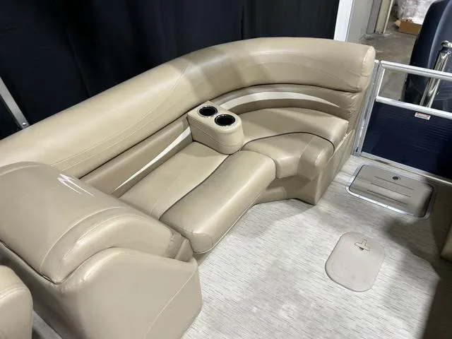 Slide: The Image of 2016 Bennington 2550 GSR boat interior with beige seating and cup holders. - 25