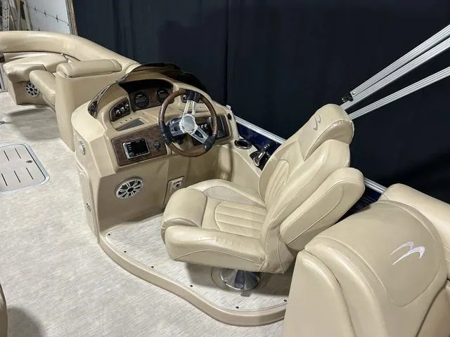 Slide: The Image of 2016 Bennington 2550 GSR boat interior with beige seating and steering console. - 7