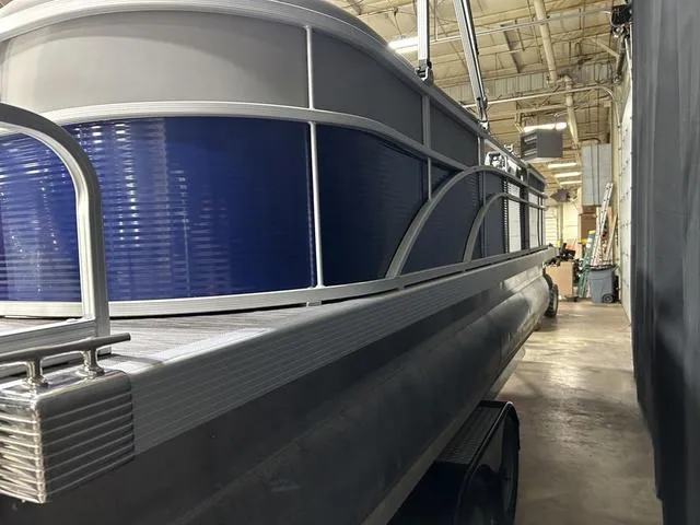 Slide: The Image of 2022 Bennington 22 SVSR pontoon boat in a warehouse setting. - 10