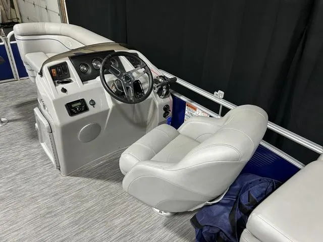 Slide: The Image of 2022 Bennington 22 SVSR boat interior with steering console and plush seating. - 11