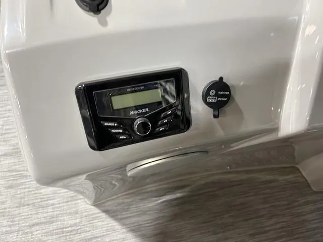 Slide: The Image of 2022 Bennington 22 SVSR boat dashboard with Kicker audio system and USB port. - 12