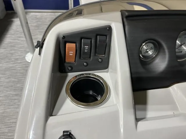 Slide: The Image of Control panel of 2022 Bennington 22 SVSR boat with switches and cup holder. - 13