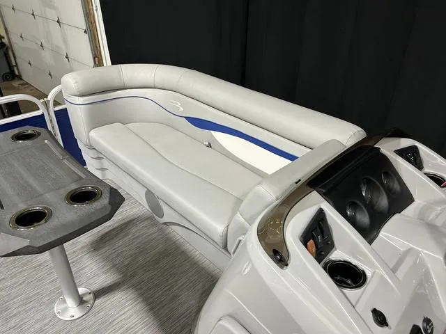 Slide: The Image of 2022 Bennington 22 SVSR boat interior with gray seating and cup holders. - 16