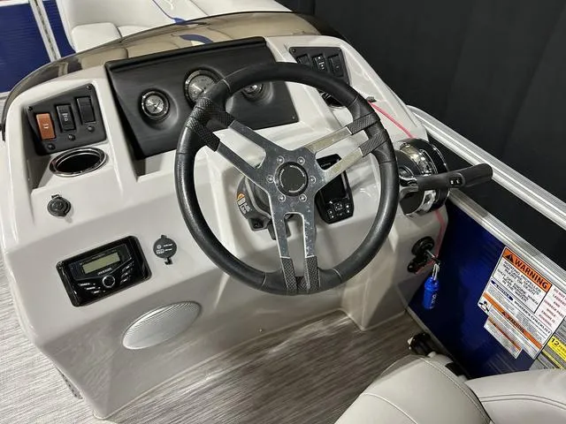 Slide: The Image of Steering console of 2022 Bennington 22 SVSR pontoon boat with modern controls and gauges. - 21