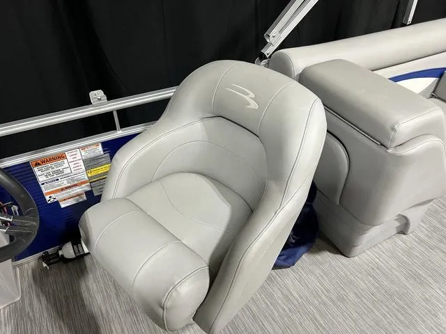 Slide: The Image of 2022 Bennington 22 SVSR boat interior with gray captain's chair and console. - 23