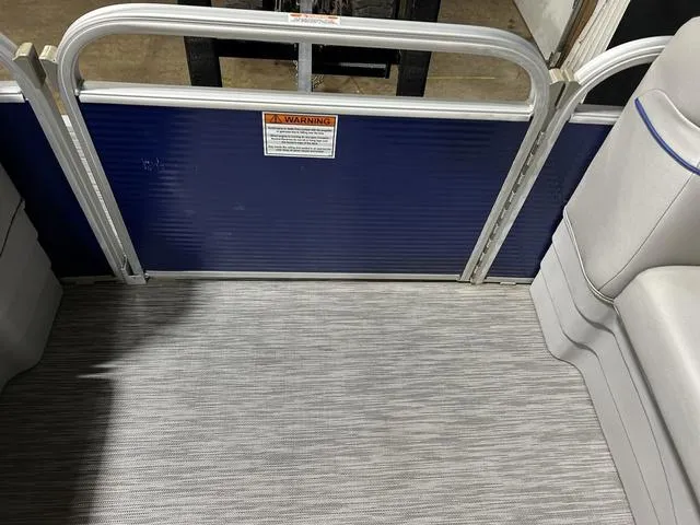 Slide: The Image of 2022 Bennington 22 SVSR boat interior with seating and safety warning sign. - 25