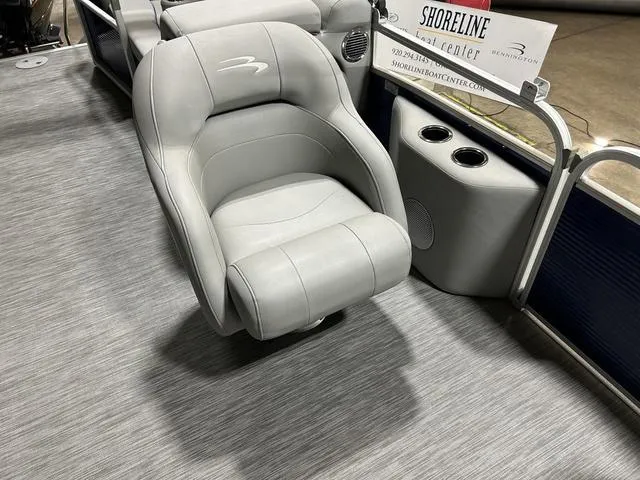 Slide: The Image of Gray captain's chair on 2022 Bennington 22 SVSR pontoon boat, with cup holders and signage. - 26
